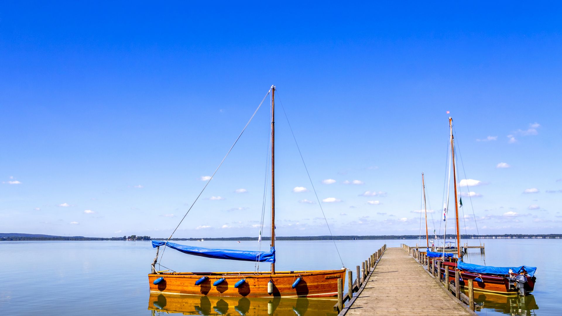 Steinhuder Meer with empty jetty and moored sailing boats